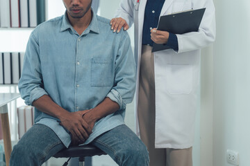 Compassionate Care: Doctor comforting a patient.  A doctor offers a reassuring hand to a concerned...