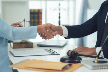 Legal Handshake: A lawyer and client shake hands, symbolizing trust, partnership, and the beginning...