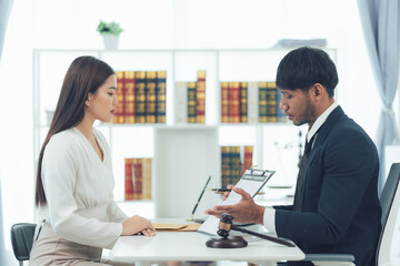 Fototapeta premium Legal Consultation: Focused discussion between a lawyer and client. Serious and professional atmosphere in a law office.