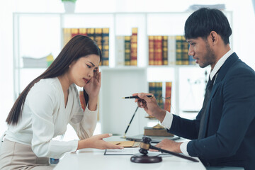 Legal Consultation: Seeking Justice - A woman anxiously seeks guidance from a lawyer in a professional office setting. The image conveys a sense of urgency and the importance of legal representation.