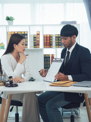 Legal Consultation: A lawyer discusses legal matters with a client in a professional setting, showcasing a commitment to understanding and providing guidance. 