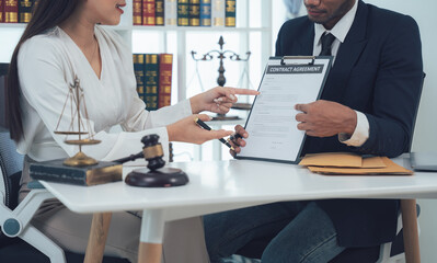 Legal Consultation:  A lawyer and client review documents together, showcasing trust and collaboration in a professional legal setting.