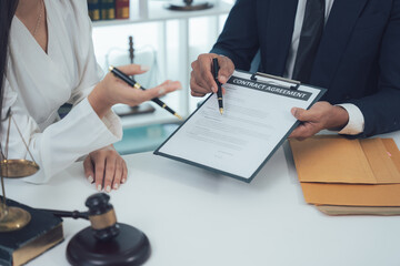 Legal Consultation: Lawyer explaining the details of a legal document to a client. Close-up shot of...