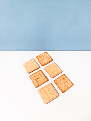 Crispy cracker with a sprinkle of sugar and the other side with full of cheese coating. The taste is sweet. Isolated on a white background