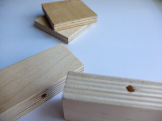 Wooden furniture parts and a bag of fittings for assembling furniture in a room against the wall.