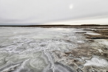 Salty shore of Lake Baskunchak on a cloudy day
