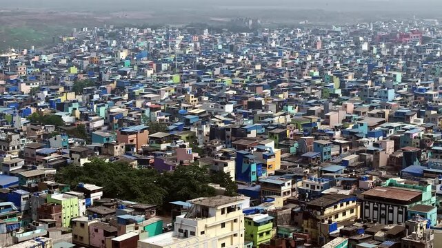 Drone view over dense shanty houses in Mumbai's Mankhurd area, showcasing vibrant colours and packed urban 11 Drone view over Mumbais slum area.