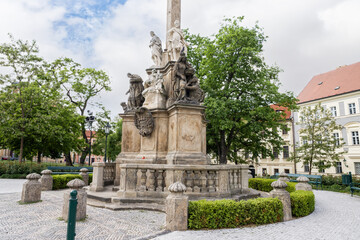 Obraz premium Group of the sculptures at the bottom of Marian Plague Column in garden on Hradcanska Square in Prague in Czech Republic