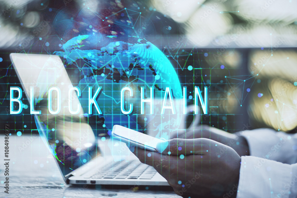 Poster Hands holding phone with blockchain text overlay, holographic global map, and laptop in the background.