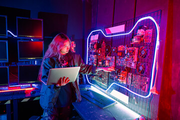Asian woman is sitting at a desk with a laptop service in server room, Thinking and solve problems, Software engineer typing coding in laptop computer at data center, Cyber security