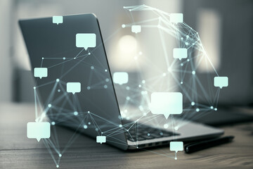Speech bubbles and network connections over a laptop on a wooden desk background.