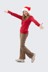 Merry Christmas Beautiful happy young blonde woman playfully holding her arms open and looking at...