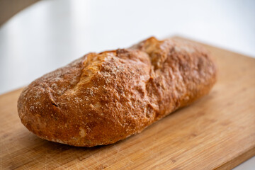 Rustic organic bread on a wooden old board