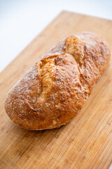 Rustic organic bread on a wooden old board