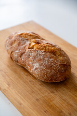 Rustic organic bread on a wooden old board
