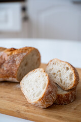 Freshly baked loaf of bread on a wooden cutting board