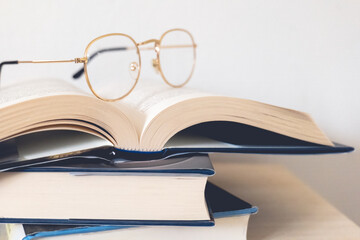 eyeglasses on top of books