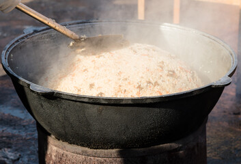 Asian national rice food called pilaf cooked with fried meat, closeup