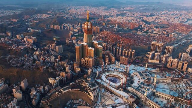 Aerial view of the Grand Mosque with the Kaaba, Islam&rsquo;s holiest site, and the Abraj Al-Bait Clock Tower illuminated by early morning sunlight in the holy city of Mecca