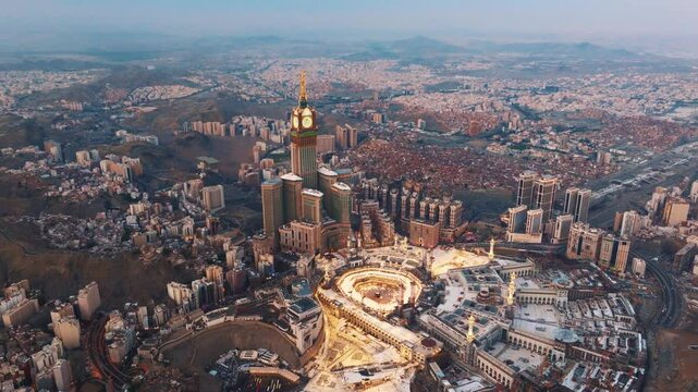 Aerial view of the Grand Mosque with the Kaaba, Islam&rsquo;s holiest site, and the Abraj Al-Bait Clock Tower illuminated by early morning sunlight in the holy city of Mecca