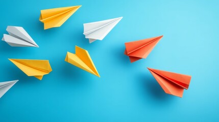 Naklejka premium Colorful paper airplanes soar against a vibrant blue backdrop. A playful image representing ideas taking flight.