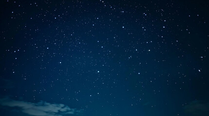 Fototapeta premium Starry night sky filled with twinkling stars over a calm landscape at dusk