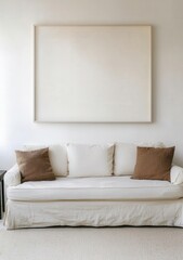 Minimalist living room interior design showcasing a cream sofa with brown cushions and a large blank canvas above.  Perfect for home decor, interior design, and real estate websites.