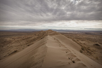 On the top of the dune horizontal clouds view