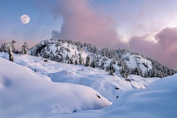 Full moon over snowy mountains landscape in the purple twilight sky. Grouse Mountain. Vancouver. British Columbia. Canada
