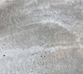 A grey concrete surface with a few small cracks