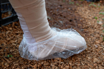 Wearing a plastic bag over the cast while walking