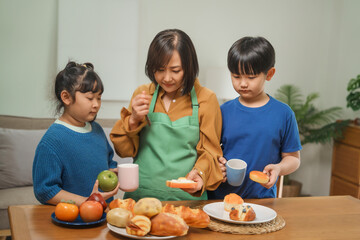 A mother and her children prepare fresh bread, milk, and fruits for breakfast, enjoying a productive and joyful morning together, creating a healthy and nourishing start to their day