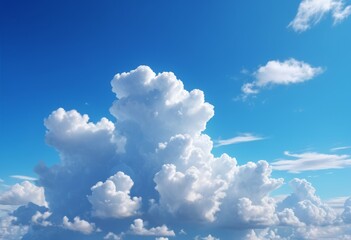 Naklejka premium Serene sky background with fluffy white clouds floating in a bright and vivid blue atmosphere.