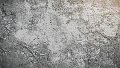 Fototapeta premium Close-up of a rough, textured concrete wall with a gray tone. The surface shows subtle details, cracks, and imperfections, ideal for backgrounds, industrial themes, or design projects requiring a raw 
