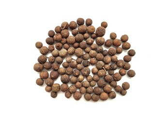 Raw portion of allspice seeds on a white background.