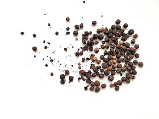 Aromatic portion of raw pepper seeds, on a white background.