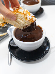 Portion of roscón de reyes with hot chocolate