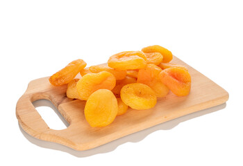 Sweet dried apricots on a wooden kitchen board, close-up, isolated on a white background.