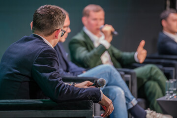 Engaged business leaders participate in a dynamic panel discussion, sharing insights with audience...