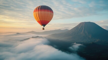 Hot Air Balloon Soaring Above Misty Mountains