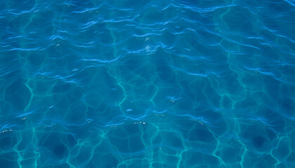 Fototapeta premium Crystal-clear turquoise water ripples gently across the sun-drenched pool's surface