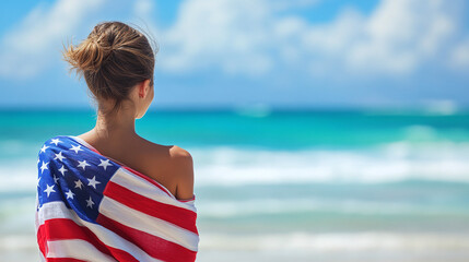 Young happy woman in US flag walking on tropical beach on sunny day