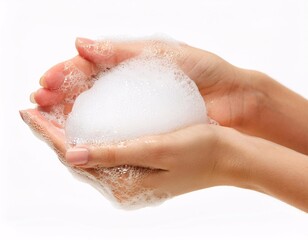 Fototapeta premium women's hands covered in soap foam, with a white background that emphasizes freshness and cleanliness.