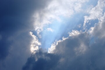 the sun shines through the clouds