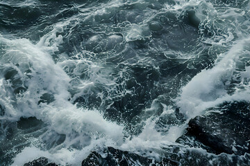 Obraz premium Ocean's Fury: A close-up of churning ocean waves crashing against rocky shores, capturing the raw power and untamed beauty of nature's force. 