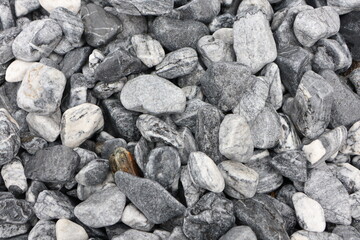 Textured Gray and White Pebbles Offer Aesthetic Appeal for Landscaping and Decoration Purposes