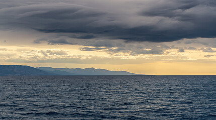 Obraz premium Serene Mediterranean Seascape Under Dramatic Sky