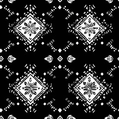 Fototapeta premium A bold and graphic Aztec-inspired pattern in black and white. The intricate design features geometric shapes, diamonds, and floral motifs. Perfect for fashion, home decor, and digital projects