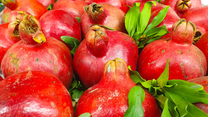 Pomegranate garnet fruit. Fresh raw garnet fruit pile on the counter in the market.