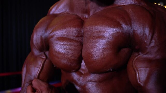 body part details of a bodybuilder. bodybuilder in competition, detail. 4k video.